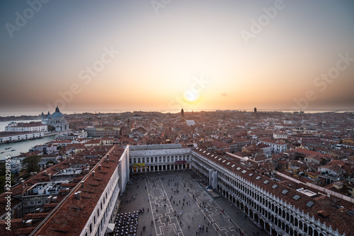 Venice city view from height. Houses roofs and sky at the sunset. Warm colors. Tilt-shift