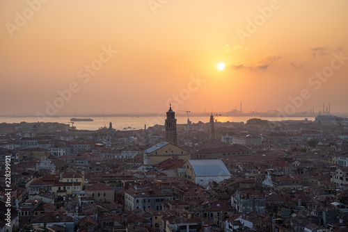 Venice city view from height. Houses roofs and sky at the sunset. Warm colors. Tilt-shift