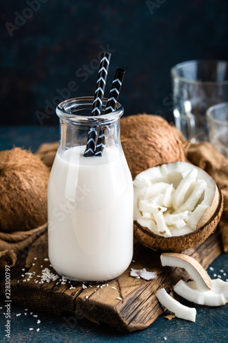 Fresh coconut milk in glass and bottle, vegan non dairy healthy drink