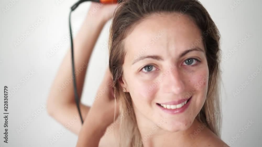 Beautiful Woman Drying Healthy Long Straight Hair Using Hair Dryer