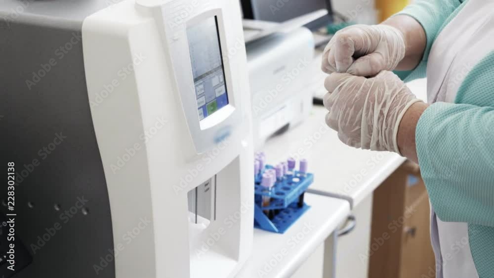 Close-up automated blood tests robotic machine, medical equipment. Modern clinical diagnostic laboratory tools work in hospital. Concept of health, medicine.