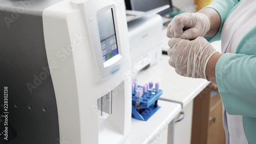 Close-up automated blood tests robotic machine, medical equipment. Modern clinical diagnostic laboratory tools work in hospital. Concept of health, medicine.