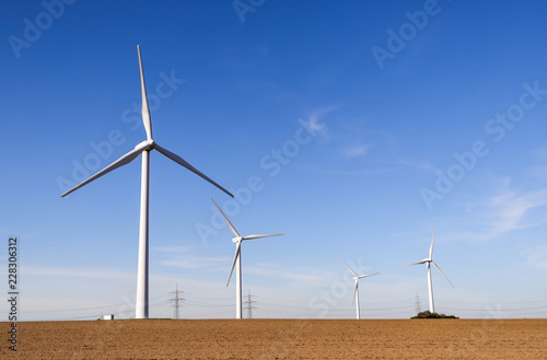 Wind turbines generating electricity with blue sky