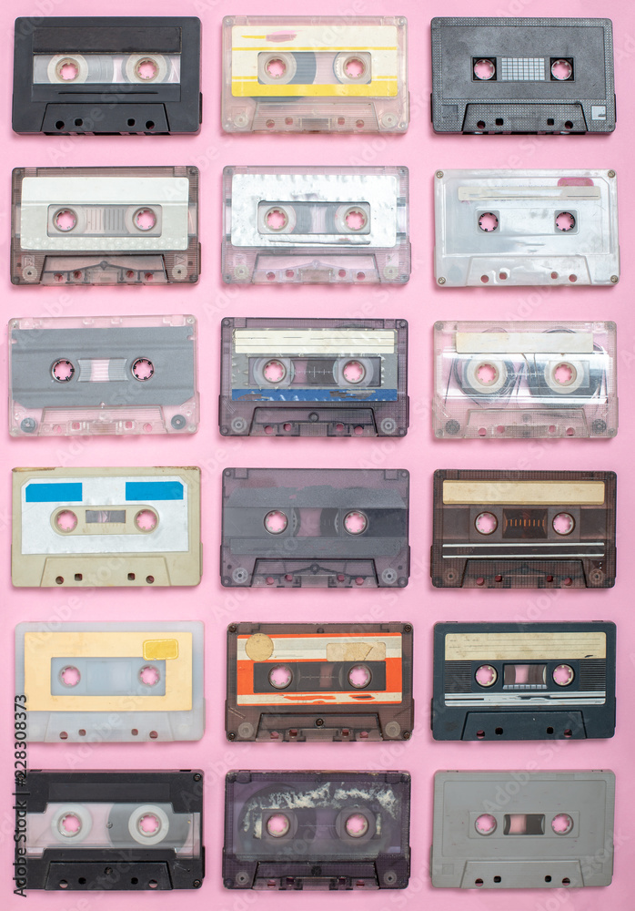Set of old cassettes on a light pink surface Set of old cassettes on a light pink surface