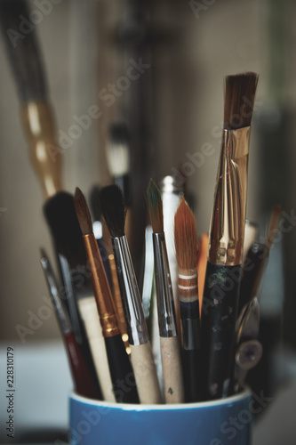 Stylized photo of paint brushes in a glass
