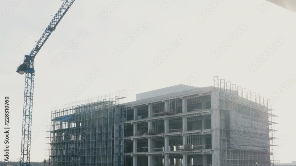 Big crane and high building under construction Big crane and high building under construction