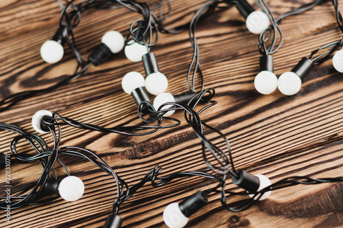 Shut down holiday electric garland on old weathered wooden table