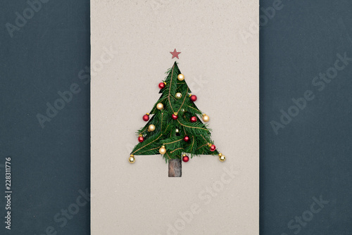 Text or logo empty copy space in vertical top view cardboard with natural eco decorated christmas tree pine.Xmas winter holiday season party social media card background