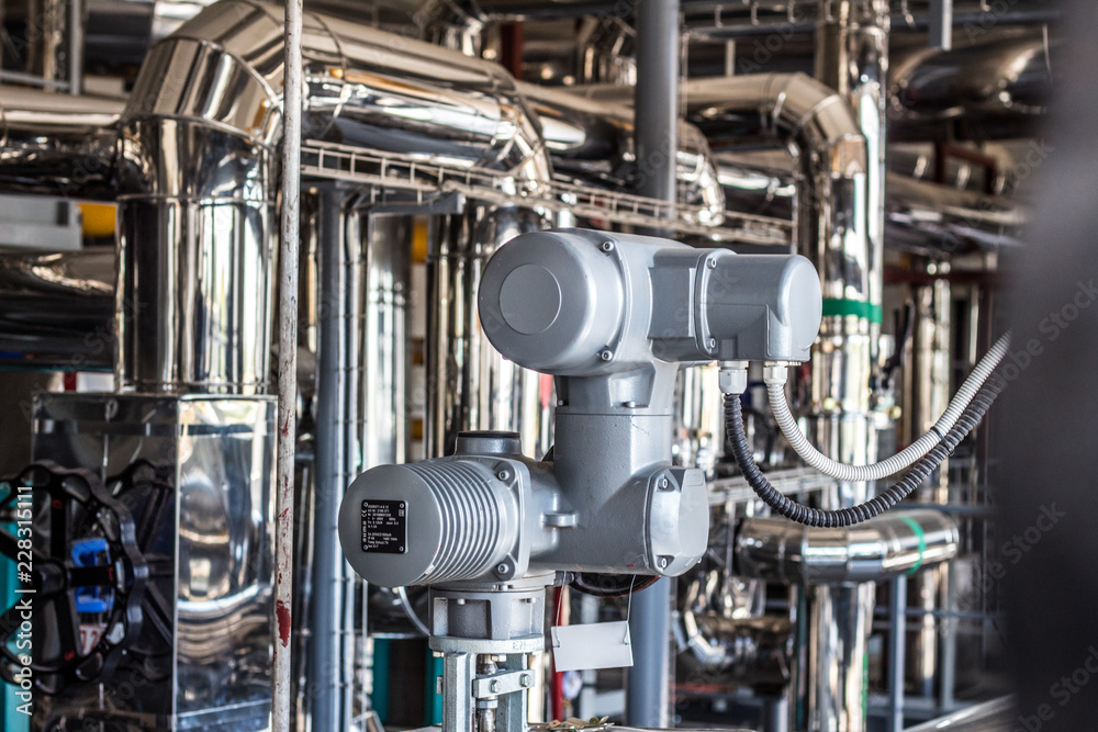 Equipment, cables and piping as found inside of a industrial workshop