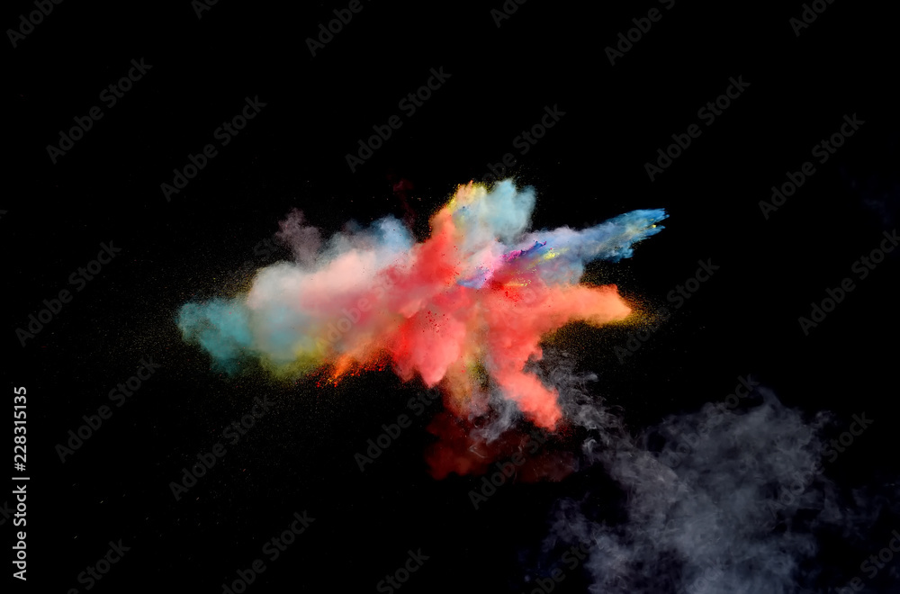 Colorful explosions of powder paint and flour combined  together explode in front of a black background to give off fantastic  multi colored cloud forms.