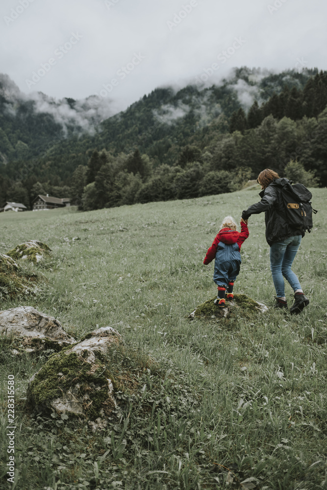 Austria, Vorarlberg, Mellau, mother and toddler on a trip in the mountains