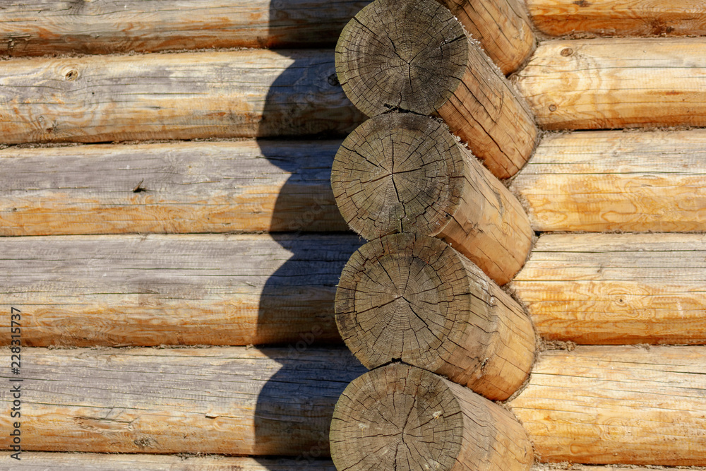 Wall with log house in the house as a background Wall with log house in the house as a background