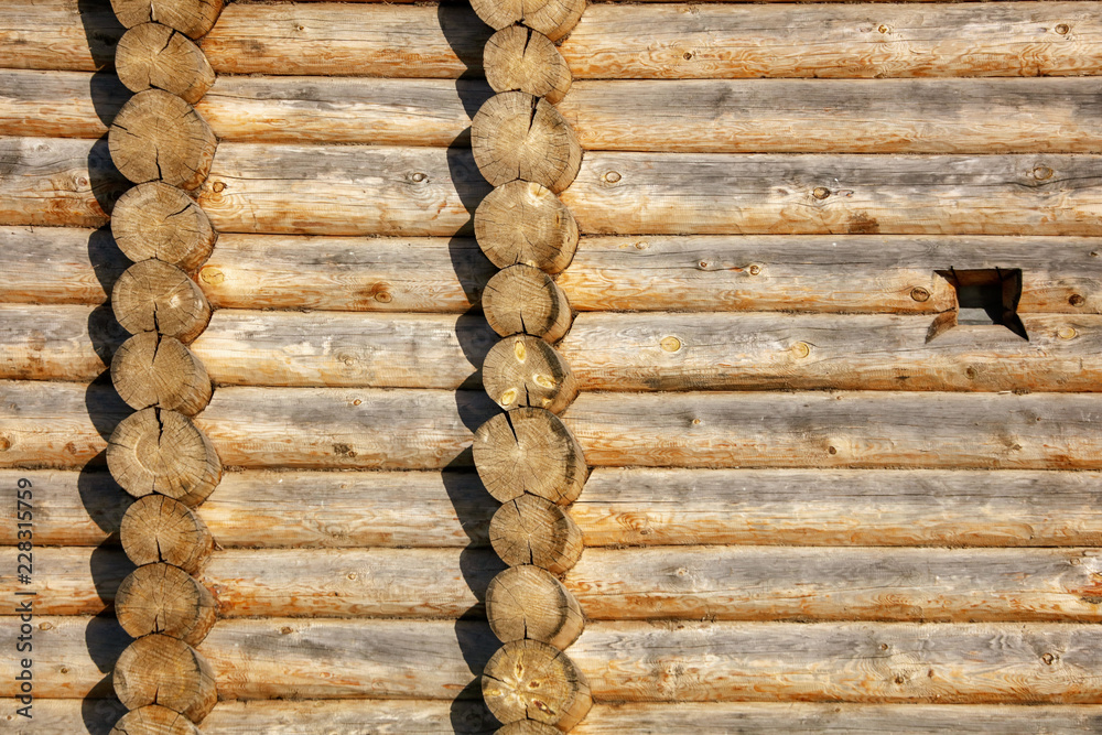 Wall with log house in the house as a background Wall with log house in the house as a background