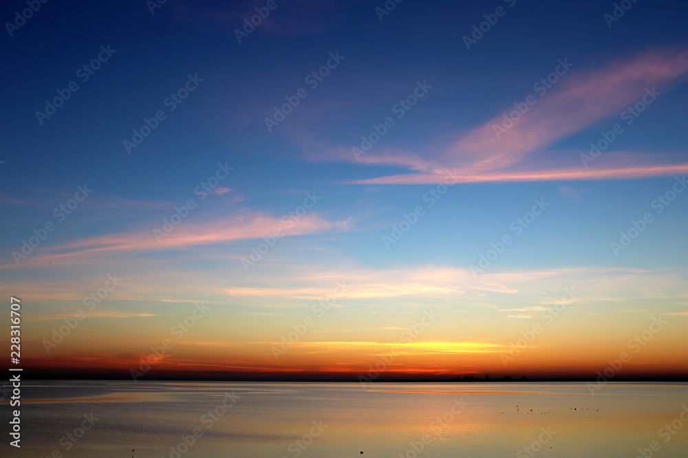 colorful sunset over the sea dark horizon