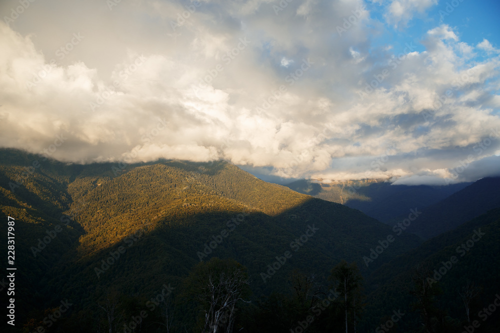 Mountain landscape at sunset in thick clouds