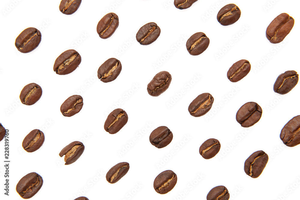 Coffee beans arranged on a white background as texture with copy space
