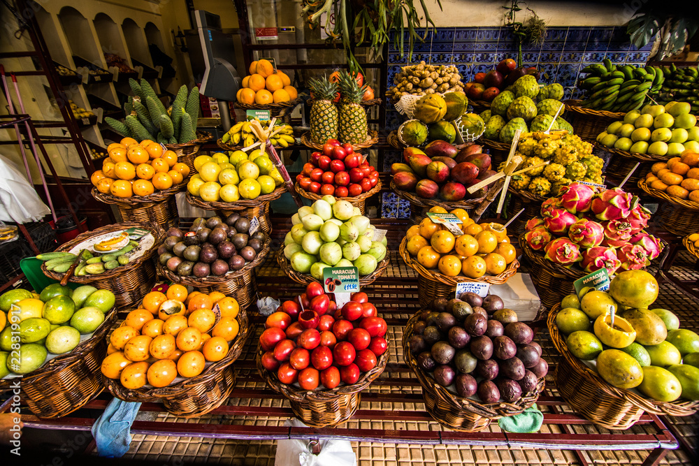 Many fresh and ripe exotic fruits on traditional farmer market Mercado dos Lavradores, Funchal, Madeira island, Portugal