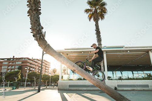 Guy riding and jumping with a bmx bike