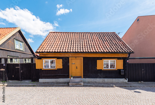 old house with roof on background of blue sky