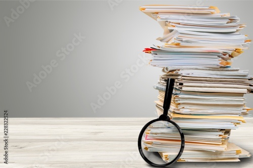 File folders with documents and magnifying glass photo