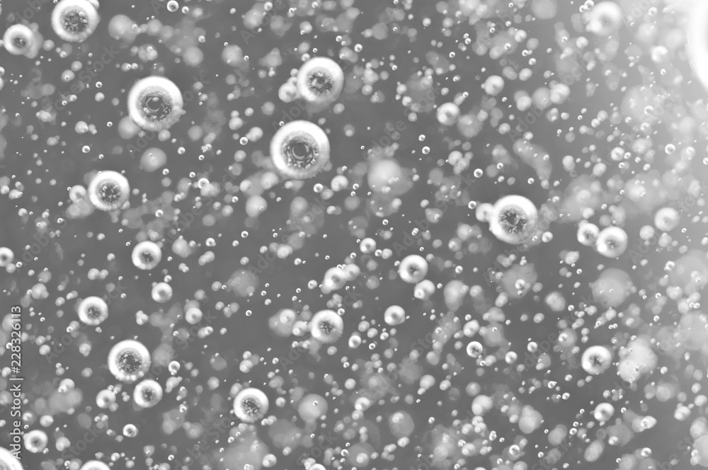 Bubbles of oxygen under water. Water black and white structure. Macro.
