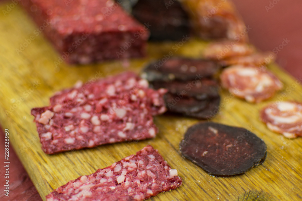 Smoked sausages are cut on a cutting board.