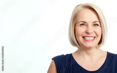 Friendly smiling middle-aged business woman isolated on white ba