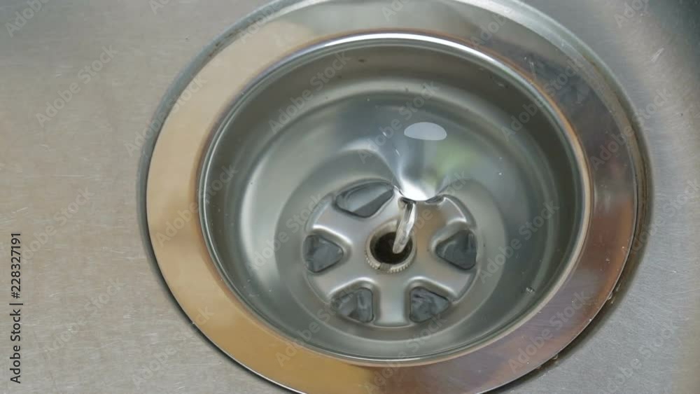 Water flowing down hole in kitchen sink Water flowing down hole in kitchen sink