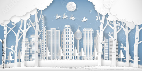 Paper art and cut of Santa Claus on the sky in the winter season with cityscape , forest and snow  as digital craft style concept. vector illustration