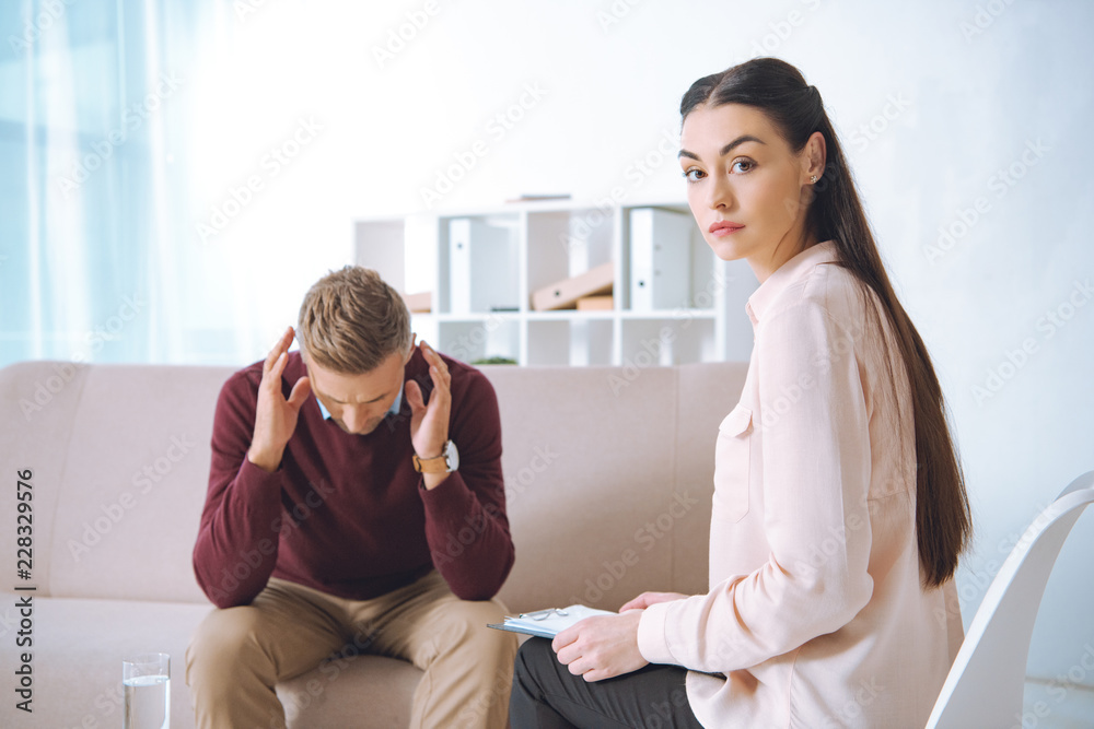 male patient having therapy appointment at psychologist office male patient having therapy appointment at psychologist office