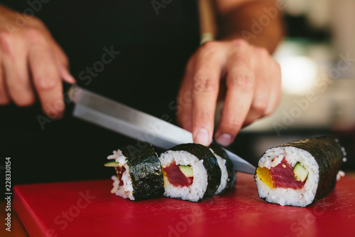 Man cutting fresh sushi