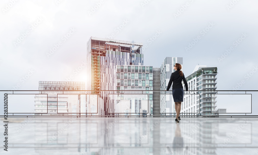 Sunrise above skyscrapers and businesswoman facing new day Sunrise above skyscrapers and businesswoman facing new day