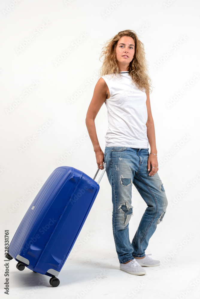 Beautiful blonde woman with blue plastic suitcase Beautiful blonde woman with blue plastic suitcase
