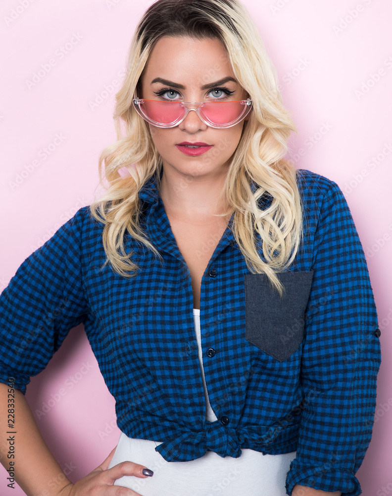 Young blonde woman wearing shirt and sunglasses