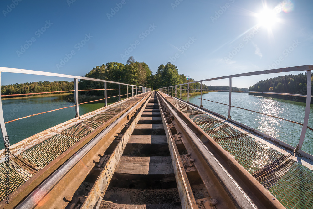 iron steel frame construction of narrow gauge railway bridge across the river. Wide angle view