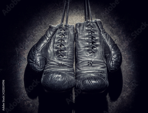 old boxing gloves on a dark background © BortN66