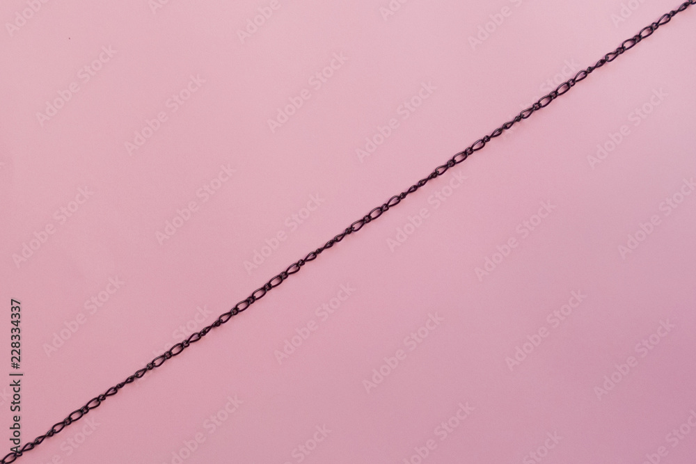 Black chain on a sheet of paper Black chain on a sheet of paper