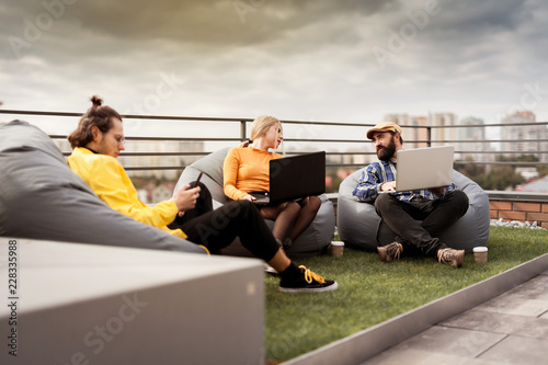 Business people communication, office teamwork. 30 years old people on roof coworking area. photo