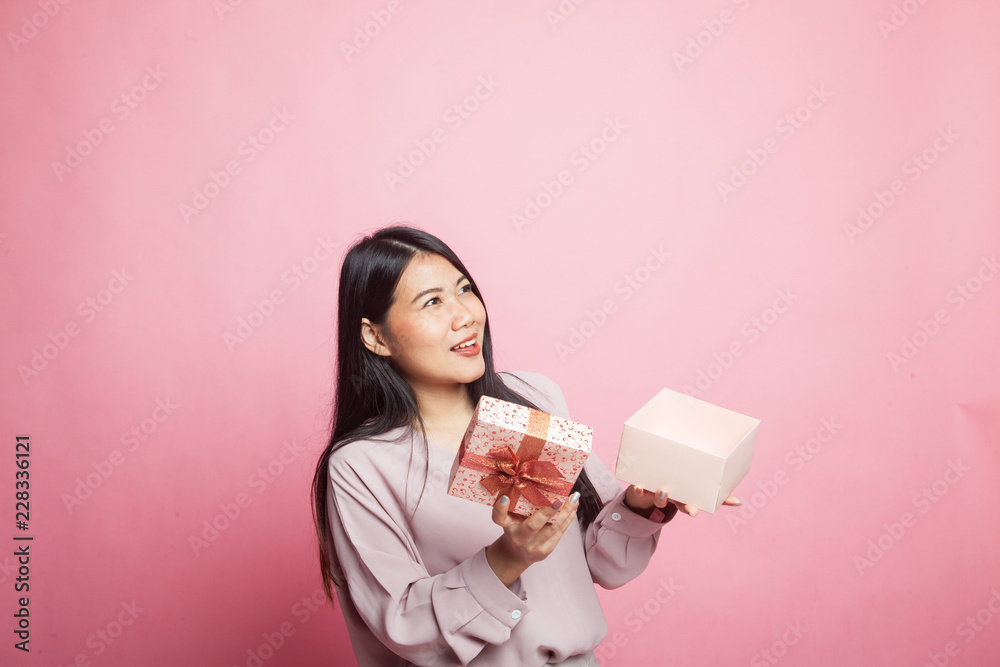 Young Asian woman open a gift box. Young Asian woman open a gift box.