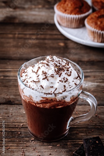 Fototapeta Naklejka Na Ścianę i Meble -  Hot chocolate drink with whipped cream in a glass on a wooden background