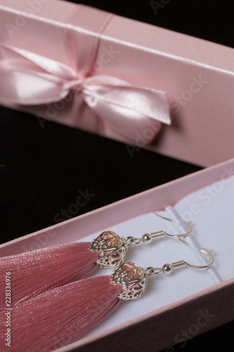 Earrings made of viscose handmade. Together with wrapping gift boxes. Against the black background. © f2014vad