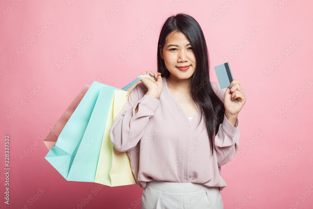 Young Asian woman with shopping bag and blank card. Young Asian woman with shopping bag and blank card.
