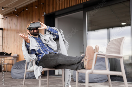 Futuristic virtual reality glasses. Adult man use VR tech headset.