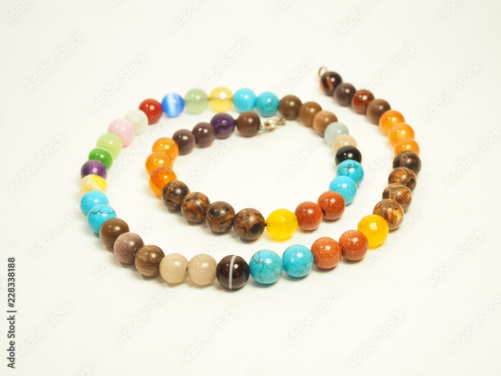 Multi-clored beads on white background Multi-clored beads on white background