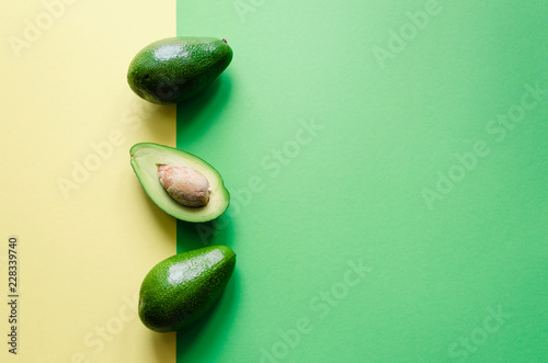 Organic avocado on color background