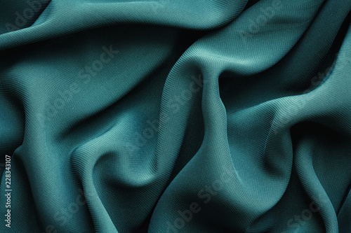 green fabric with large folds,  abstract background photo