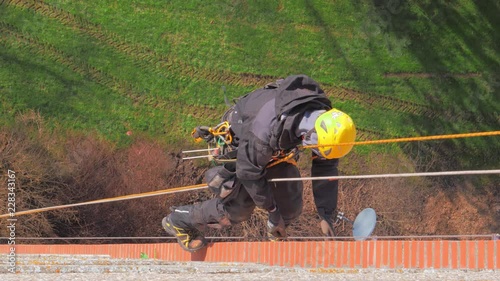 Climbers working on residential building facade at high altitude