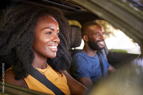 Young black couple smiling in a car during a road trip © Monkey Business