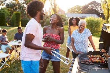 Couple laughing at a multi generation family barbecue
