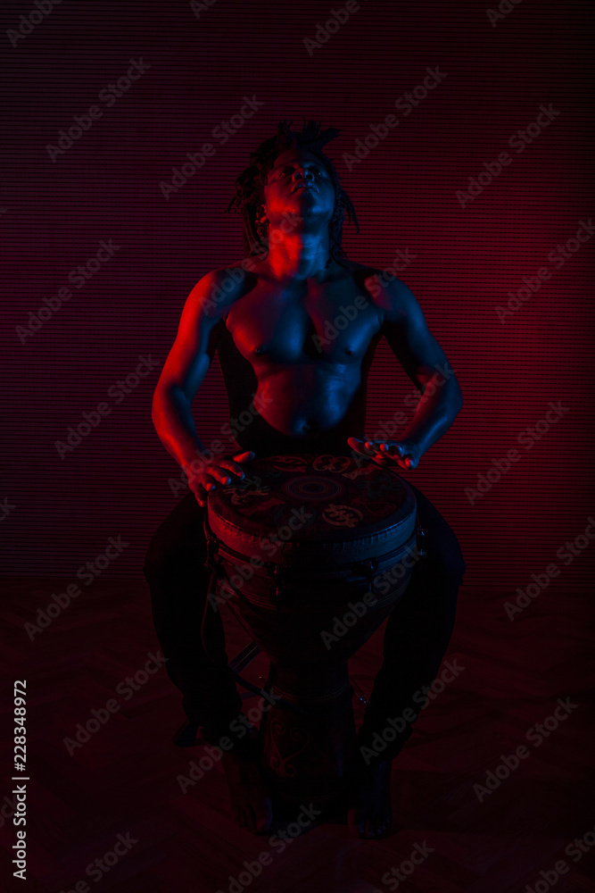 young african man plays the tam tam young african man plays the tam tam